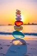 © IKARTS - colored Stones balance on beach, sunrise shot
