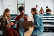 © Drazen - Happy female students using wireless technology in lecture hall.