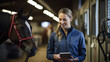 A veterinarian with tablet stands next to a horse in the background of a stall. Created with Generative AI technology.