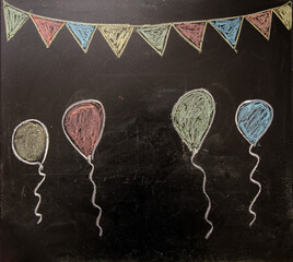 Balloons and pennants on a blackboard