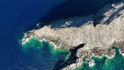 Wall Mural - view from the air on the waves and rocks. sea relaxation and travel. azure water on the sea. a brigh