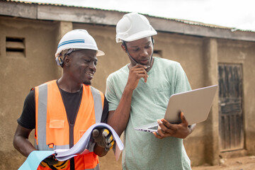 two african engineers working with a laptop