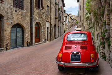 Wall Mural - old nostalgia red car in the italy street, tuscany