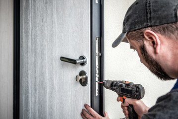 Locksmith repairing entrance door lock