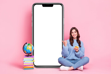 Wall Mural - Full length portrait of attractive person hold telephone direct finger empty space poster pile stack book globe isolated on pink color background