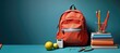 Orange school backpack from which sticks out, a ruler, a pen, pencils and notebooks, on a plain background. Back to school concept for new knowledge and education, college and university education