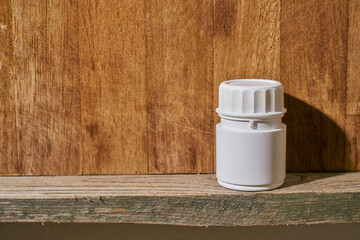 a white plastic painkiller bottle on a shelf