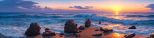 Panorama Of A Sunset Over The Ocean With Waves Crashing On The Shore And Several Big Stones In The Foreground. Seascape Illustration With Sand Beach, Cloudy Sky And Setting Sun. Generative AI