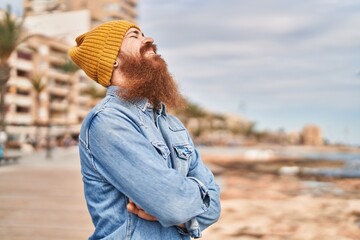 Canvas Print - Young redhead man smiling confident standing with arms crossed gesture at seaside