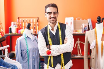 Canvas Print - Young hispanic man tailor smiling confident standing with arms crossed gesture at atelier