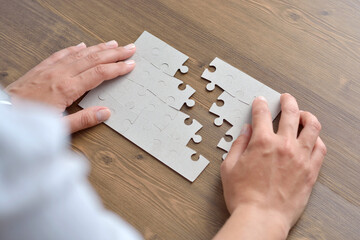 Wall Mural - Image of businesswoman connecting elements of white puzzle