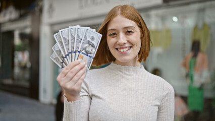 Poster - Young blonde woman smiling confident holding dollars at street