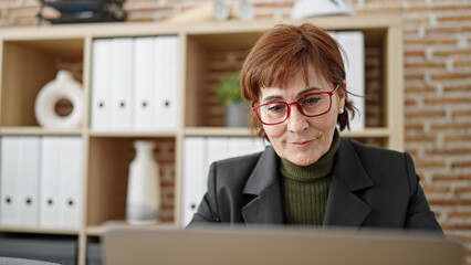 Sticker - Mature hispanic woman business worker using laptop working at office