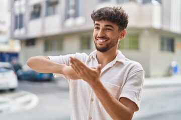 Canvas Print - Young arab man smiling confident doing spend money gesture at street