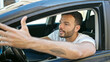 © Krakenimages.com - Young hispanic man stressed driving car at street