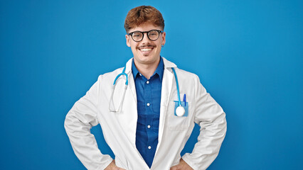 Young hispanic man doctor smiling confident standing over isolated blue background