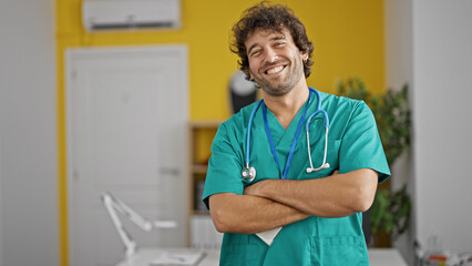 Poster - Young hispanic man doctor smiling confident standing at clinic