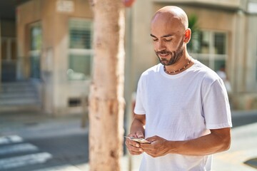 Wall Mural - Young bald man smiling confident counting dollars at street