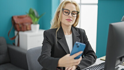 Wall Mural - Young blonde woman business worker make selfie by smartphone working at the office