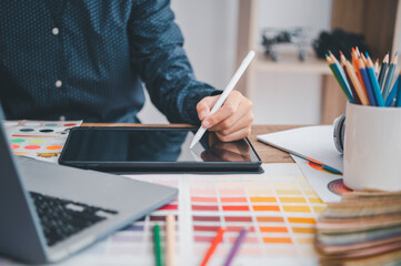 Fototapete - Graphic designer architects who work with laptops and color comparison tables for design work..