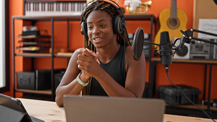 Canvas Print - African american woman reporter having radio show at music studio