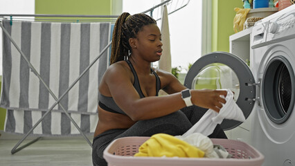 Sticker - African american woman washing clothes at laundry room