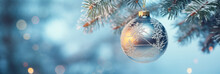 A Blue Christmas Ball Hangs On A Snowy Fir Branch