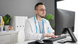 © Krakenimages.com - Hispanic man doctor using computer working at the clinic