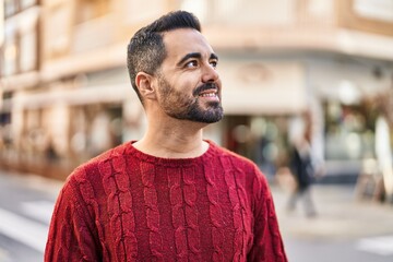 Wall Mural - Young hispanic man smiling confident standing at street