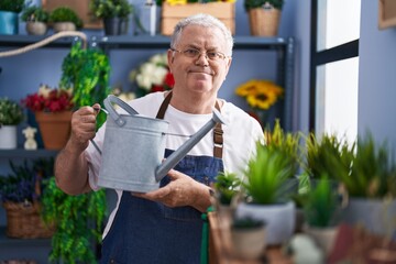 Poster - Middle age grey-haired man florist watering plant at florist