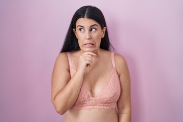 Canvas Print - Young hispanic woman wearing pink bra thinking worried about a question, concerned and nervous with hand on chin