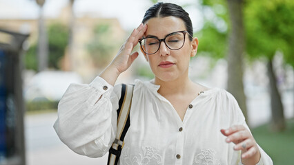 Poster - Young beautiful hispanic woman suffering for headache at street