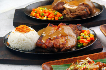 Wall Mural - Freshly cooked sizzling pork belly served with mushroom gravy and rice