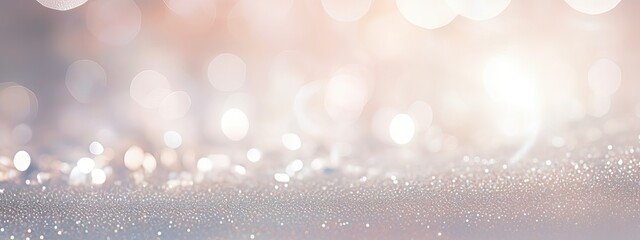 Beautiful festive background image with sparkles and bokeh in pastel pearl and silver colors. Selective focus, shallow depth of field