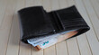 A leather wallet stuffed with euro notes and dollars. Portfel skórzany wypchany banknotami euro i dolarami