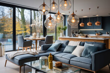 Pendant Lights Hanging On Ceiling In Modern Kitchen And Cushions Arranged On Sofa In Living Room
