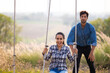 © NVB Stocker - romantic couple in love sitting on rope swing. love, relationship. Hispanic latin male and woman