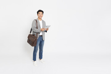 Portrait of young Asian businessman smile and holding tablet and brown leather bag isolated on white background, Full body composition