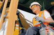 © Parilov - Industry worker portrait. Man driver builder operate crane or excavator at construction site