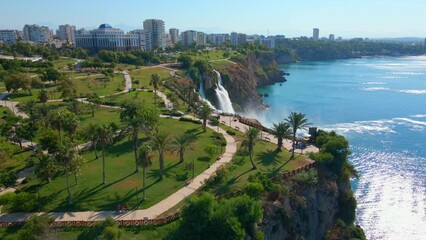 Wall Mural - Slowmotion aerial video of the Lower Duden Waterfall in the city of Antalya. The drone moves above the Duden park revealing the surrounding park and buildings.
