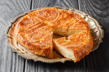 Wall Mural - Kouign Amann is a pastry made with a lot of butter from the Brittany region of France closeup on the plate on the table. Horizontal