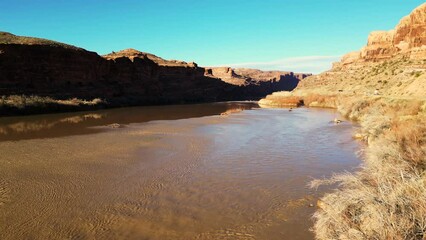 Wall Mural - Moab, Utah, where the landscape has been carved by the Colorado River Erosion, looking at the Red Mudded Colorado River Landscape