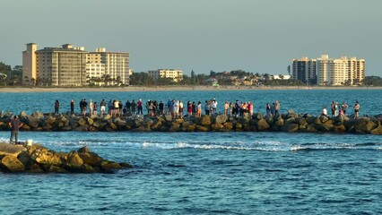 Canvas Print - People enjoying vacation time on Nokomis jetty pier in Florida. Seaside summer activities on fresh air