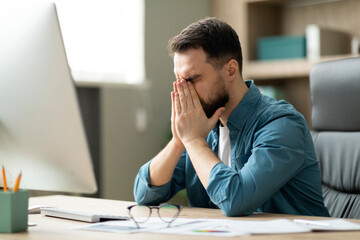 Aufkleber - Work Burnout. Tired Young Businessman Sitting At Desk In Office, Rubbing Eyes