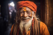 © ADDICTIVE STOCK - Generative AI image of cheerful Indian senior man in traditional clothes with long beard and glasses looking at camera against blurred background
