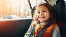 Happy Girl In A Child Car Seat Wearing A Seatbelt While Traveling By Car.