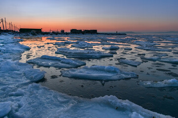 Wall Mural - Blocks of ice in the sea against a lilac sunset sky 