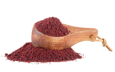 Ground sumac spice pile in wooden spoon isolated on a white background