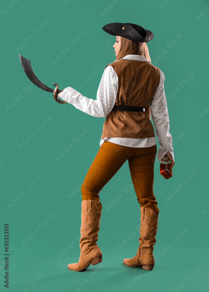 Beautiful female pirate with sword and rum on green background