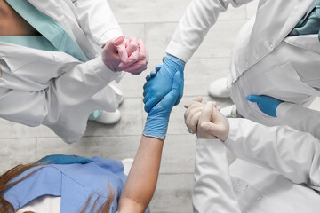 Wall Mural - Doctors in medical gloves at clinic, top view